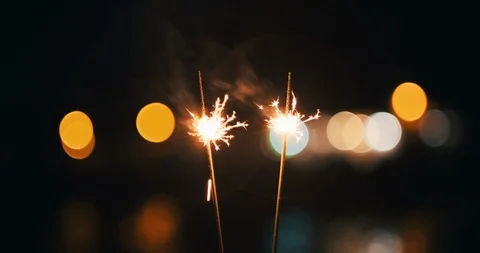 A bright burning wands of Bengali fire bokeh of the evening city sunset of day Stock-Footage 119341464