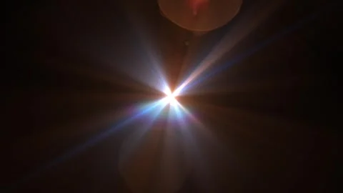 Bright Burst of Light with Multicolored Flare Effects in Darkness Vídeo Stock 340528509