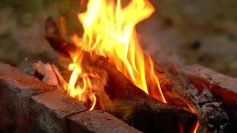 Bright campfire burning brightly inside a brick fire pit with tall flames Stock Footage 341682711
