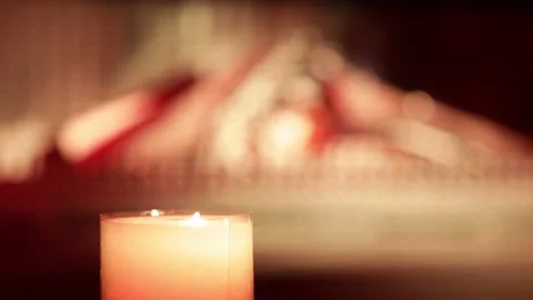 Bright candle light, a burning fireplace in the background Video stock 167424876