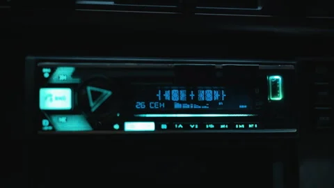 Bright car dashboard nighttime scene, Nighttime vehicle stereo with glowing Stock Footage 327731062