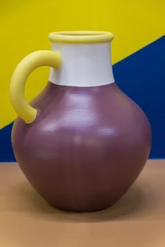 Bright ceramic multi-colored jug. Bright background. Art. Stock Photos