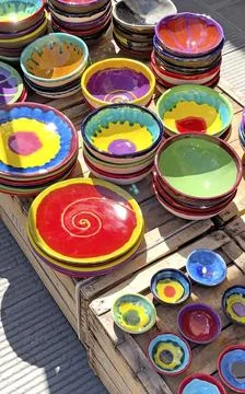 Bright ceramic plates, handmade tableware, Italy. Needlework and hobbies. Stock Photos