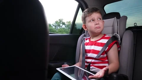 Bright child in car, Educational content on tablet, Vacation with gadgets Stock Footage 311896223