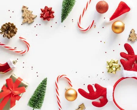 Bright Christmas flat lay frame of holiday decorations on white background wi Stock Photos