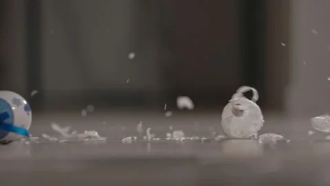 Bright Christmas tree decorations fall to the floor and break. Slow motion Stock Footage 145315551