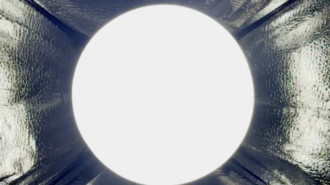 Bright circular led light glowing inside reflective softbox tunnel creating Stock Footage 327130909