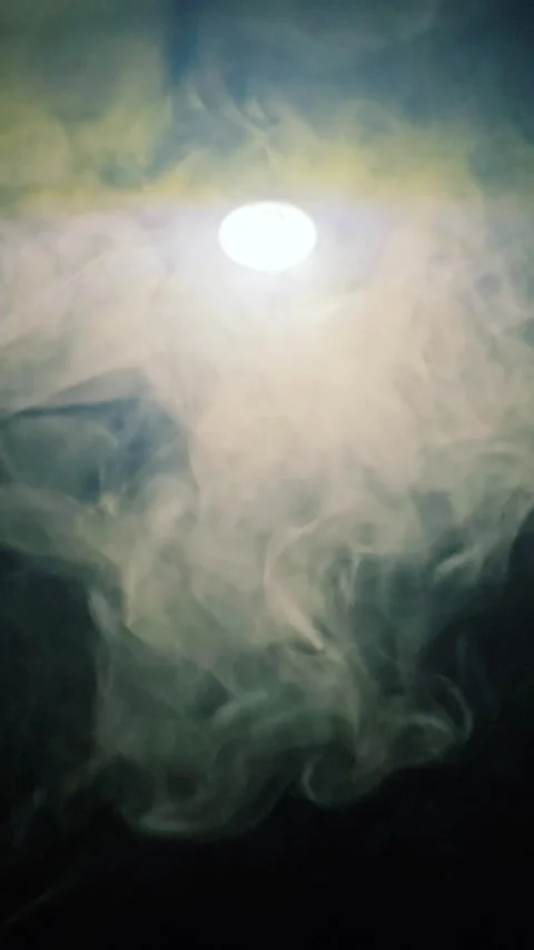 Bright circular light glowing through dense, swirling smoke and fog 스톡 동영상 341828209