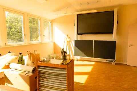 Bright classroom interior with large screen and natural light streaming in Stock Photos