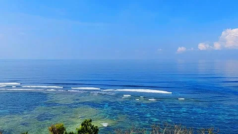Bright, Clear, Blue Sky and Calm Ocean Waters with Gentle Sea Waves Vídeos de archivo 343479950