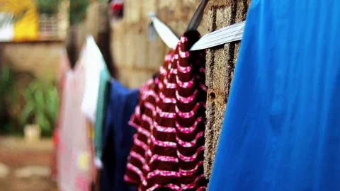 Bright Clothes Drying on Rough Concrete Wall, Shallow Focus Stock Footage 338189883