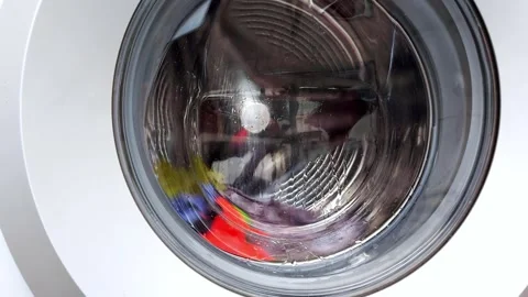 Bright Clothes Spin in Washer Drum: A Vivid Whirl of Color and Motion Video stock 315089324
