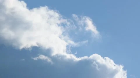Bright cloud moving and dispersing against blue sky in close up Stock Footage 172218522