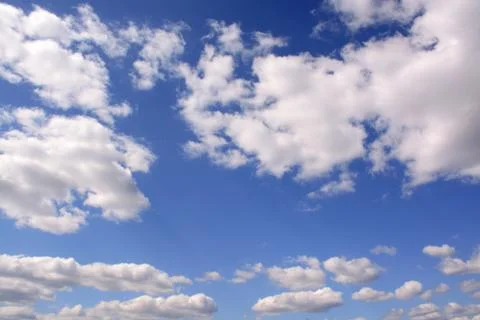 Bright clouds in a saturated blue sky.	 Stock Photos