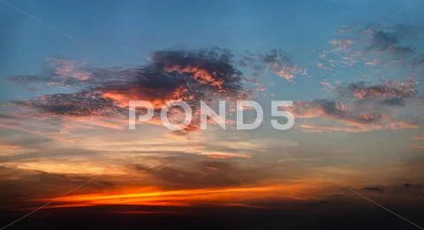 Bright clouds at sunset light Stock Photos