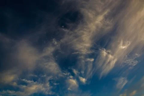 Bright clouds in the twilight sky. Stock Photos