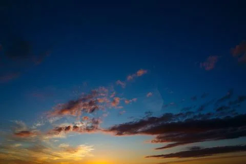 Bright clouds in the twilight sky. Stock Photos