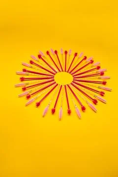 Bright colored brow brushes arranged in a circle on a yellow background dur.. Stock Photos