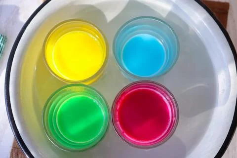 Bright colored drinks floating in water during a summer gathering at an outdoor Stock Photos