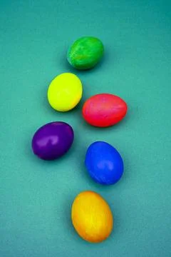 Bright Colored Easter Eggs Arranged Neatly On a Blue Background Stock Photos