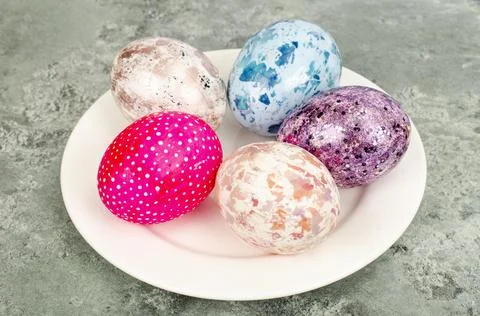 Bright colored Easter eggs on platter, holiday background. Studio Photo Stock Photos