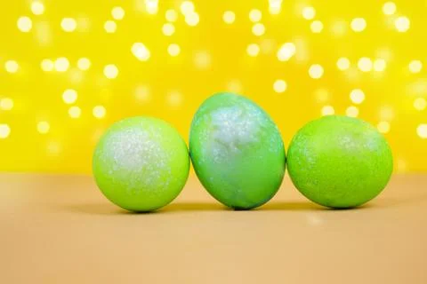 Bright colored Easter eggs on a yellow background. Easter concept. Stock Photos