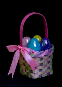 Bright Colored Eggs In A Easter Egg Basket Stock Photos