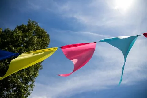 Bright colored flags against the sky Stock Photos