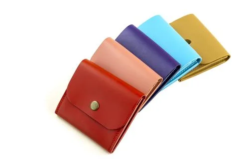 Bright colored leather wallets lie in a row. on a white background Stock Photos