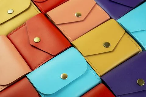 Bright colored leather wallets lie close to each other Stock Photos