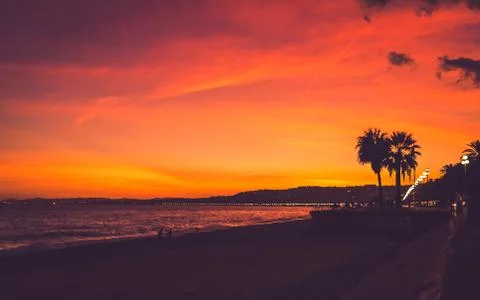 Bright colored sunset on beach in Nice Stock Photos