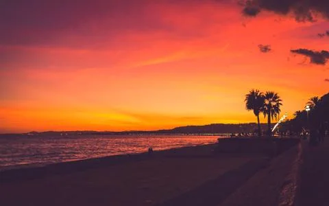 Bright colored sunset on beach in Nice Stock Photos