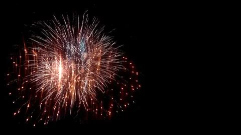 Bright colorful fireworks exploding in the dark night sky, celebration back.. Stock Photos