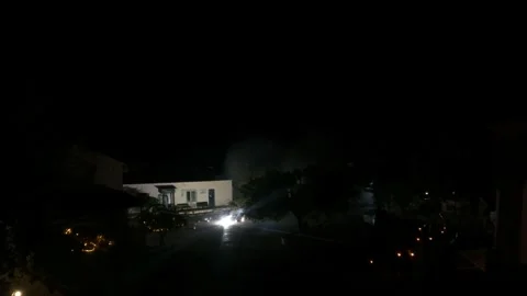 Bright Colorful Fireworks Exploding in Night Sky Over Dark Village Square 動画素材 326567038