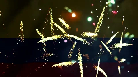 Bright colorful fireworks exploding in the night sky over the flag of colombi Stock Footage 343690377