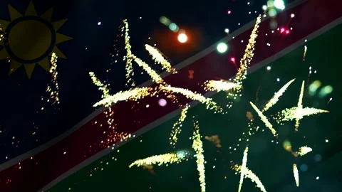 Bright colorful fireworks exploding in the night sky over the flag of Namibia Video stock 343690395