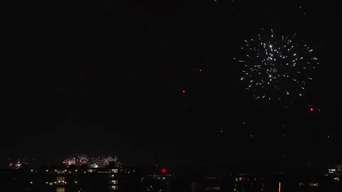 Bright Colorful Fireworks Exploding Over City Night Skyline Stock Footage 320318140