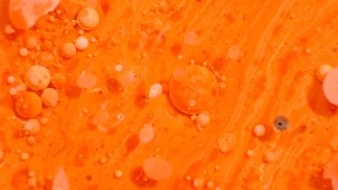 Bright colorful orange bubbles on the surface of the water. Abstract paint bu Illustrazione stock