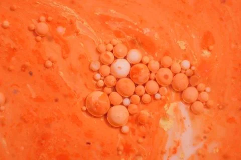 Bright colorful orange bubbles on the surface of the water. Abstract paint bu イラスト素材