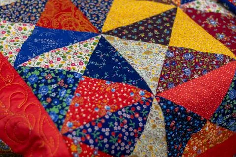 Bright, colorful patchwork quilt featuring variety of floral patterns and s.. Stock Photos