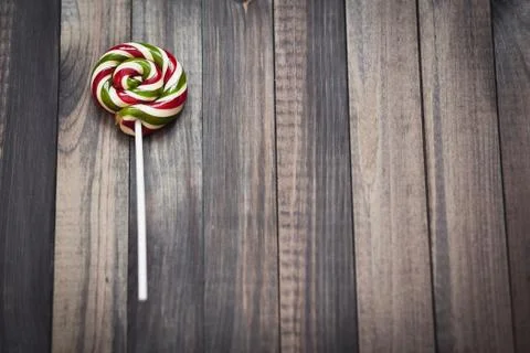 Bright colorful round lollipop wooden background close view from above Stock Photos