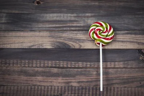 Bright colorful round lollipop wooden background close view from above Stock Photos
