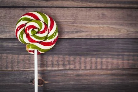 Bright colorful round lollipop wooden background close view from above Stock Photos