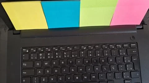 Bright colorful sticky notes attached to a black laptop screen frame Stock Photos