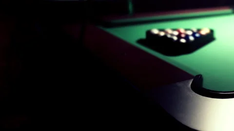 Bright Colors Shine on a Pool Table in a Dimly Lit Game Room Stock Footage 344909969