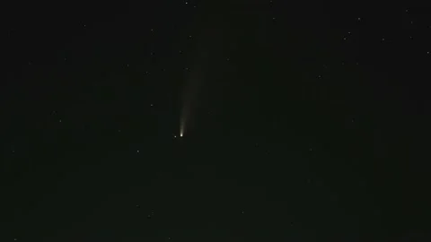 A bright comet in the night sky with falling stars. Stock Footage 144625179