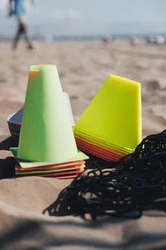 Bright cones rest on sandy beach Stockfoto's