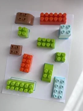 Bright construction blocks arranged on a sheet of paper Stock Photos