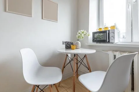 Bright Corner Kitchen Table with Flower Vase Stock Photos