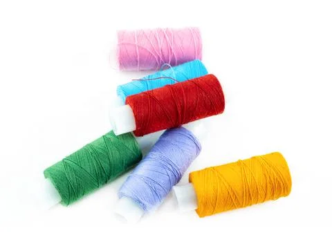Bright cotton sewing threads multicolored on isolated background Stock Photos